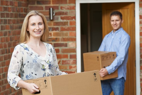 Professional movers handling packed boxes in Reigate